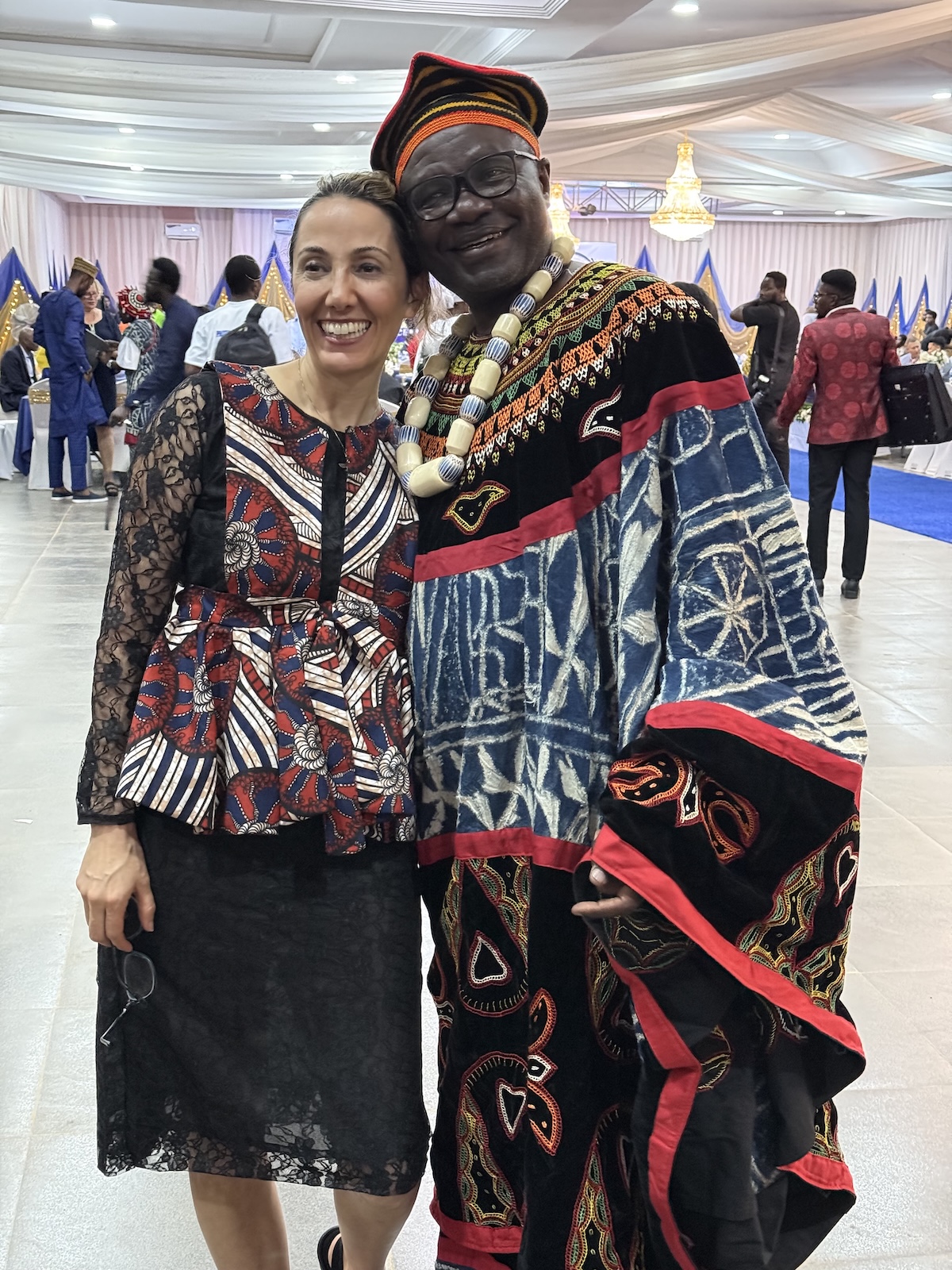 Two people smiling in patterned clothing