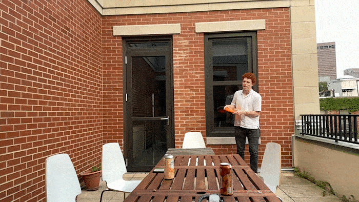 Slow-motion video of Andy hurling a frisbee at the patio wall